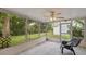 Screened patio featuring ceiling fan, and view of backyard landscaping at 8600 Village Mill Row, Hudson, FL 34667