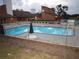 Community pool with a fence and lounge chairs at 8600 Village Mill Row, Hudson, FL 34667