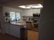 Bright kitchen with stainless steel appliances, white cabinetry, and a skylight providing natural light at 8600 Village Mill Row, Hudson, FL 34667