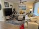 Comfortable living room featuring a large sectional sofa, hardwood floors, and coastal-themed decor for a relaxing atmosphere at 8600 Village Mill Row, Hudson, FL 34667