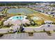 Aerial view features a lakefront community with a resort-style pool, tennis courts, clubhouse and parking at 11504 Sage Canyon Dr, Riverview, FL 33578