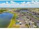 Aerial view showcases a community with a lake, pools, and well-maintained streets lined with attractive houses at 11504 Sage Canyon Dr, Riverview, FL 33578