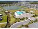 Aerial view of community pool, lake, and clubhouse in a neighborhood of single-Gathering homes at 11504 Sage Canyon Dr, Riverview, FL 33578