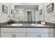 Modern bathroom showcasing a double sink vanity, granite counters and a large mirror at 11504 Sage Canyon Dr, Riverview, FL 33578