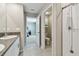 Well-lit bathroom with a granite sink and a shower, leading to the open bedroom at 11504 Sage Canyon Dr, Riverview, FL 33578