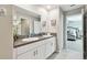 Bathroom features a double sink vanity with granite counters, white cabinets and neutral paint at 11504 Sage Canyon Dr, Riverview, FL 33578