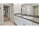 Bathroom featuring double vanity, granite countertops, and separate doors for walk-in closet and shower at 11504 Sage Canyon Dr, Riverview, FL 33578