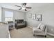 Bright neutral Bedroom featuring a ceiling fan, gray crib and a sitting chair at 11504 Sage Canyon Dr, Riverview, FL 33578