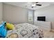 Bright bedroom with wood-look floors, featuring a ceiling fan and a TV at 11504 Sage Canyon Dr, Riverview, FL 33578