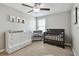 A cozy Bedroom with a dark wood crib, dresser, and changing station at 11504 Sage Canyon Dr, Riverview, FL 33578
