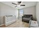 Inviting Bedroom with a comfortable crib, dresser, and soft natural light from the window at 11504 Sage Canyon Dr, Riverview, FL 33578