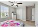 Bedroom with light walls and floor, featuring a window, closet, dresser, ceiling fan, and closet at 11504 Sage Canyon Dr, Riverview, FL 33578