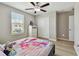 Cozy bedroom featuring wood-look floors, a ceiling fan, and ample natural light at 11504 Sage Canyon Dr, Riverview, FL 33578