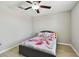 Comfortable bedroom with wood-look flooring and a ceiling fan, perfect for relaxation at 11504 Sage Canyon Dr, Riverview, FL 33578