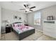 Bedroom with light walls and floor, features a ceiling fan, window, and matching dressers and nightstands at 11504 Sage Canyon Dr, Riverview, FL 33578