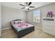 Light-filled bedroom boasts wood-look floors, a ceiling fan, and a large window at 11504 Sage Canyon Dr, Riverview, FL 33578