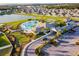 An aerial view of community amenities including a clubhouse, pool, and parking area at 11504 Sage Canyon Dr, Riverview, FL 33578