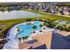 Resort-style community pool, clubhouse, tennis courts and lake providing residents with ample recreation options at 11504 Sage Canyon Dr, Riverview, FL 33578