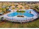 Stunning aerial view of the neighborhood pool and clubhouse, complete with lounge chairs, palm trees and shade at 11504 Sage Canyon Dr, Riverview, FL 33578