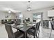 Dining room open to living area with modern table setting and views of the screened patio at 11504 Sage Canyon Dr, Riverview, FL 33578