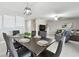 Dining room with a dark wood table set for six, open to the living area at 11504 Sage Canyon Dr, Riverview, FL 33578