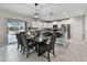 Bright, open dining space connecting to kitchen with a sliding door to a screened patio at 11504 Sage Canyon Dr, Riverview, FL 33578