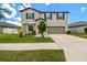 Two-story home featuring a well-manicured lawn and a two-car garage at 11504 Sage Canyon Dr, Riverview, FL 33578