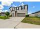 Two-story home featuring a well-manicured lawn and a two-car garage at 11504 Sage Canyon Dr, Riverview, FL 33578
