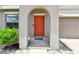 Close-up of front door with an arched entry and a garden at 11504 Sage Canyon Dr, Riverview, FL 33578