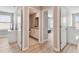Hallway view showcasing an open bathroom and bedroom with stylish interior doors at 11504 Sage Canyon Dr, Riverview, FL 33578
