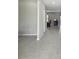 Open hallway showcasing modern tile flooring and neutral wall colors at 11504 Sage Canyon Dr, Riverview, FL 33578