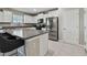 Bright kitchen features white cabinets, stainless steel appliances, and granite countertops at 11504 Sage Canyon Dr, Riverview, FL 33578