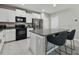 Bright kitchen featuring stainless steel appliances, white cabinets, and granite countertops at 11504 Sage Canyon Dr, Riverview, FL 33578