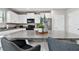 Stylish kitchen island with granite countertops, seating, and modern appliances in a bright, open-concept design at 11504 Sage Canyon Dr, Riverview, FL 33578