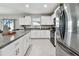 Modern kitchen featuring granite countertops, stainless steel appliances, and white cabinetry at 11504 Sage Canyon Dr, Riverview, FL 33578