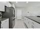 Bright kitchen featuring stainless steel appliances, white cabinets, and granite countertops at 11504 Sage Canyon Dr, Riverview, FL 33578