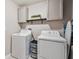 Well-lit laundry room featuring ample storage cabinets, offering convenience and organization at 11504 Sage Canyon Dr, Riverview, FL 33578