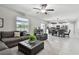 Spacious living room flowing into dining area with modern furnishings, ample natural light, and open layout at 11504 Sage Canyon Dr, Riverview, FL 33578