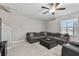 Comfortable living room offers a large sectional sofa, ottoman, and neutral decor at 11504 Sage Canyon Dr, Riverview, FL 33578