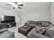 Open living room with TV, comfortable seating, and staircase access to the upper level at 11504 Sage Canyon Dr, Riverview, FL 33578