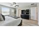 Spacious bedroom with a large television, ceiling fan and natural light from a window at 11504 Sage Canyon Dr, Riverview, FL 33578