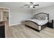 Bright main bedroom features neutral walls, modern ceiling fan, and wood-look flooring at 11504 Sage Canyon Dr, Riverview, FL 33578