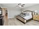 Bright main bedroom with light wood flooring, ceiling fan, and stylish furniture at 11504 Sage Canyon Dr, Riverview, FL 33578