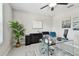 Well-lit home office featuring a modern glass desk, stylish storage, and a comfortable workspace setup at 11504 Sage Canyon Dr, Riverview, FL 33578