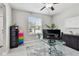 Home office with a glass desk, ample storage, and natural light from a window creating an ideal work environment at 11504 Sage Canyon Dr, Riverview, FL 33578