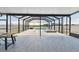 Relaxing covered patio with a large swimming pool and hot tub overlooking the water at 11504 Sage Canyon Dr, Riverview, FL 33578