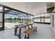 Covered patio showcases a dining table with a beautiful view of the pool and scenic lake at 11504 Sage Canyon Dr, Riverview, FL 33578