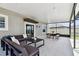 Covered patio featuring an outdoor sectional seating set, a coffee table, a dining table, and a ceiling fan at 11504 Sage Canyon Dr, Riverview, FL 33578