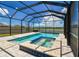 Screened-in pool and spa with inviting blue tile accents, perfect for relaxation and enjoyment at 11504 Sage Canyon Dr, Riverview, FL 33578
