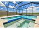 Clear blue swimming pool and spa inside a screened enclosure, offering a private and luxurious experience at 11504 Sage Canyon Dr, Riverview, FL 33578
